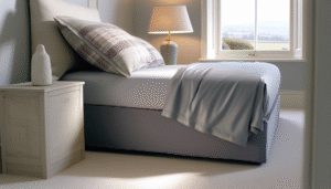 Corner of a bed with deep pocket fitted sheet in a bright modern UK bedroom