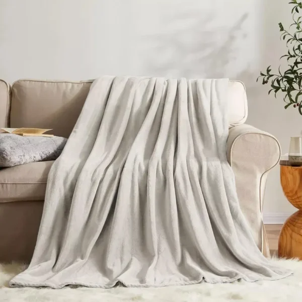 Warm mink-colored faux fur throw with ultra-soft fleece backing, perfect for cosy living spaces.