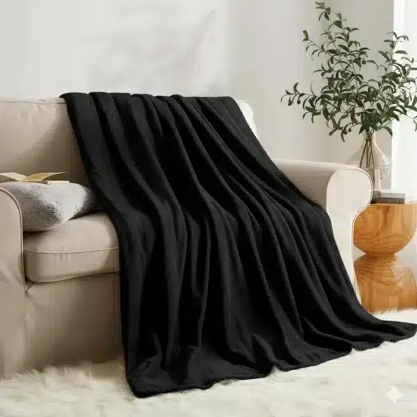 Elegant black faux fur throw blanket with soft reversible fleece, ideal for bedroom or living room.