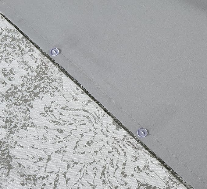 Silver grey jacquard bedding close-up showing woven damask texture