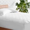 White quilted fitted mattress protector with soft padded surface for everyday bed protection