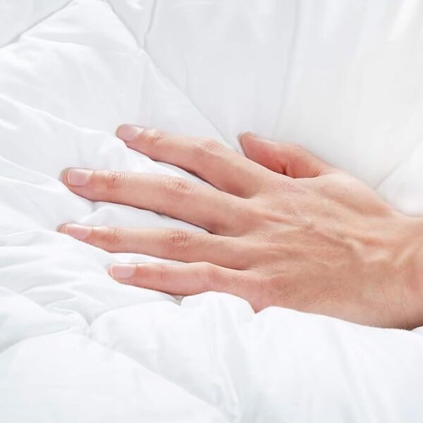 Quilted mattress protector showing fitted skirt and deep mattress coverage
