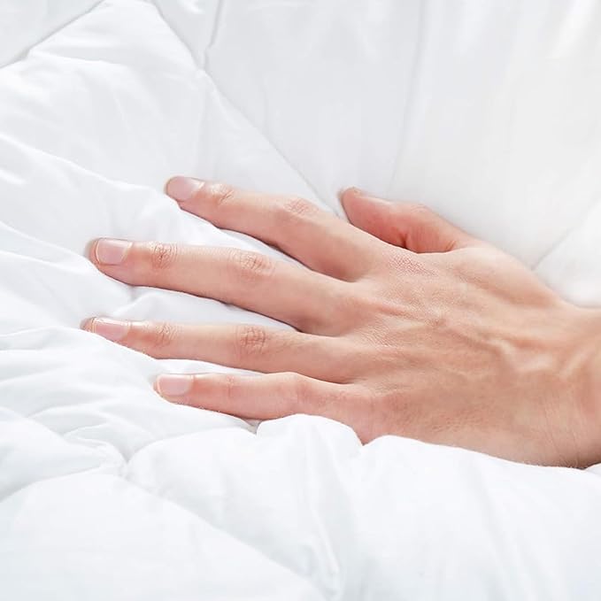 Quilted mattress protector showing fitted skirt and deep mattress coverage