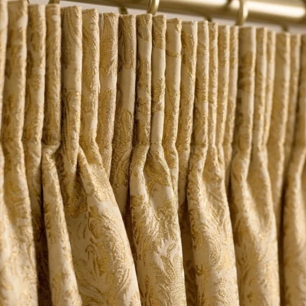 Gold pencil pleat jacquard curtain heading close up