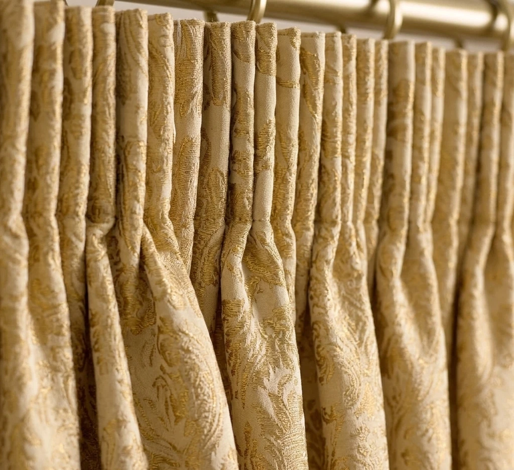 Gold pencil pleat jacquard curtain heading close up