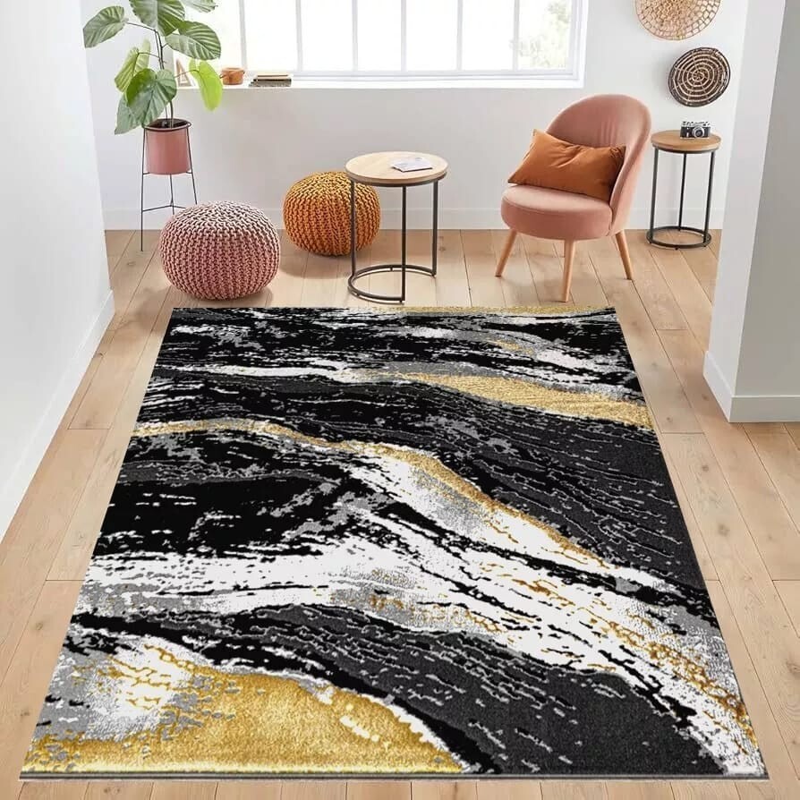 Black Jeze Modern Distressed Rug in black, grey and gold in a room setting Rugstars UK
