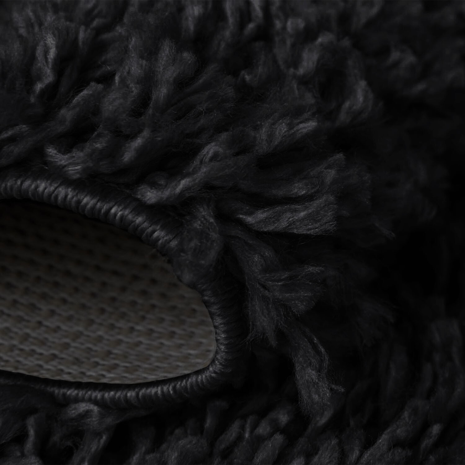 Black Verona Thick Shaggy Rug folded corner showing the backing Rugstars UK