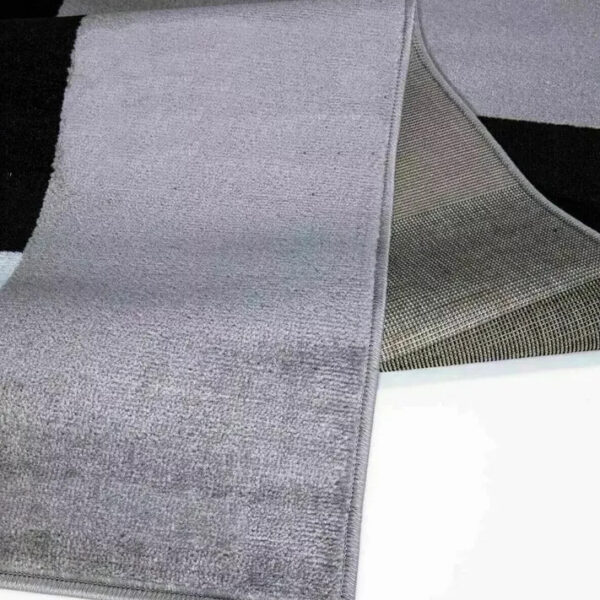 Folded corner of Grey Kilas Geometric Rug showing pile and backing Rugstars UK