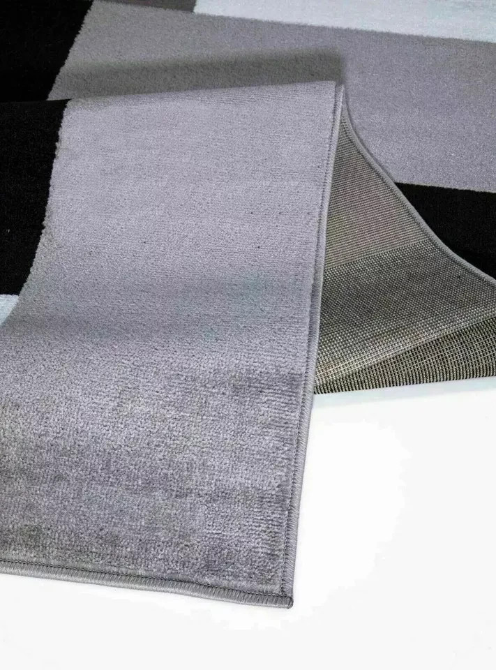 Folded corner of Grey Kilas Geometric Rug showing pile and backing Rugstars UK