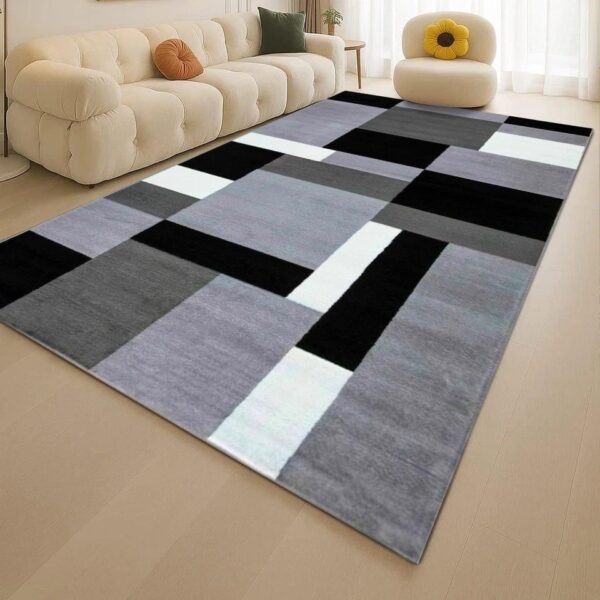 Grey Kilas Modern Geometric Rug with grey, charcoal, black and white blocks in a living room Rugstars UK