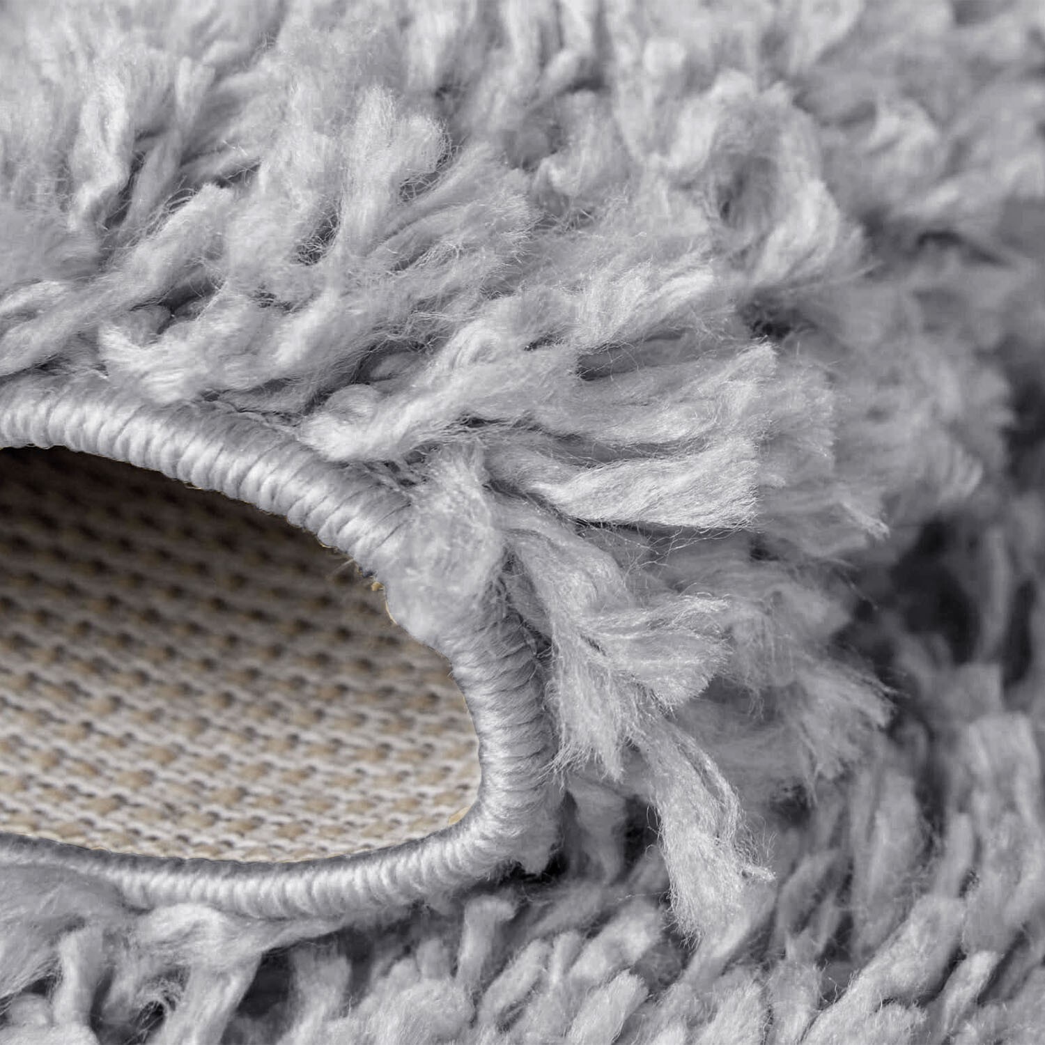Light Grey Verona Thick Shaggy Rug folded corner showing the backing Rugstars UK
