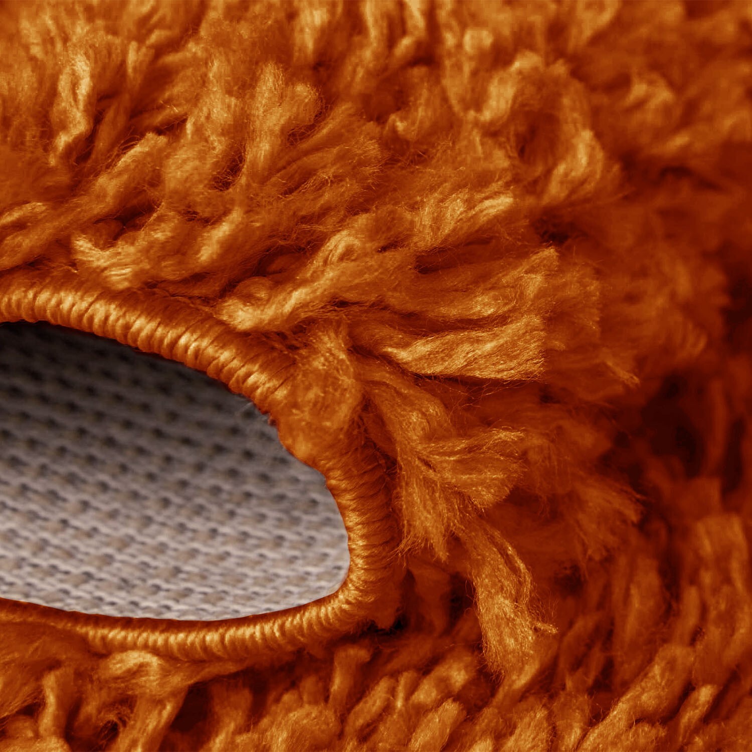 Orange Verona Thick Shaggy Rug folded corner showing the backing Rugstars UK