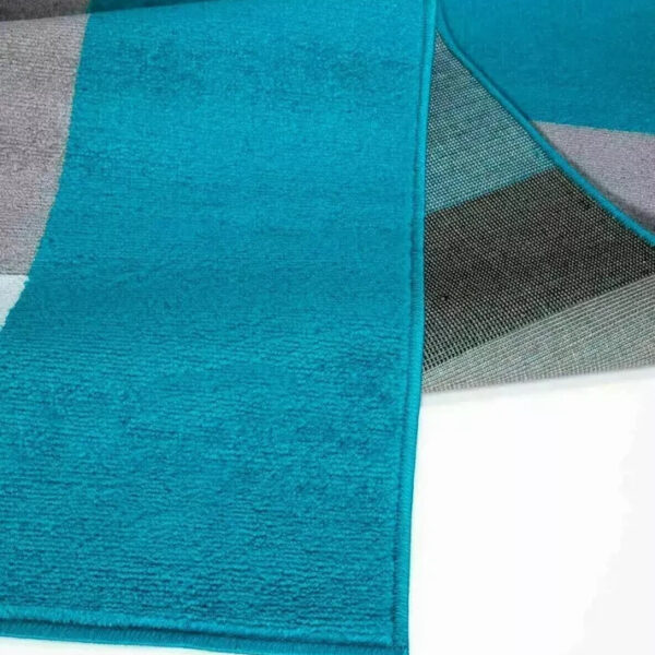 Folded corner of Teal Black Kilas Geometric Rug showing pile and backing Rugstars UK
